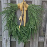 Norfolk pine front door wreath with brass bells