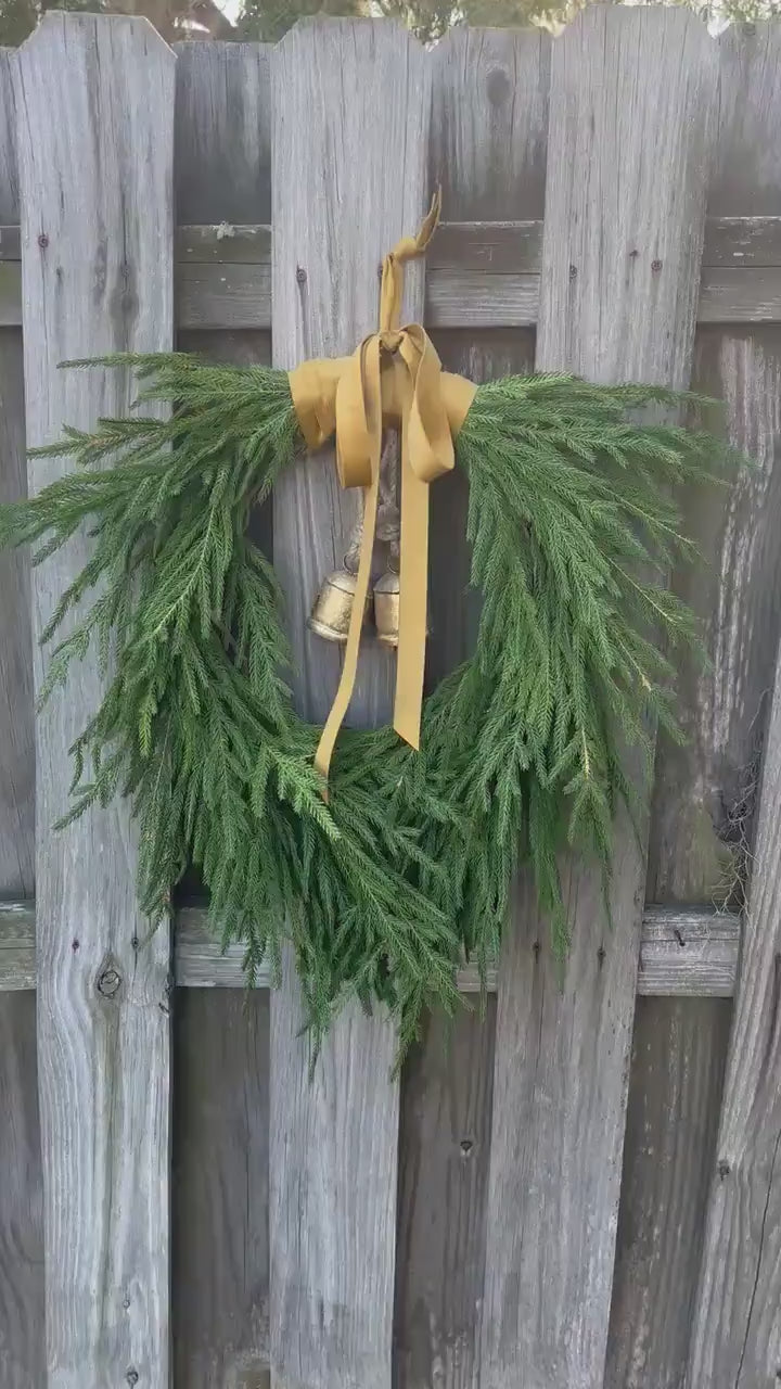 Norfolk pine front door wreath with brass bells